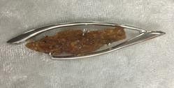 A Small Piece of Orange Stone Set in A Metal Holder — Crystal Cauldron In South Mackay, QLD