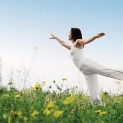 A Woman in White Clothing Balances Gracefully — Crystal Cauldron In South Mackay, QLD