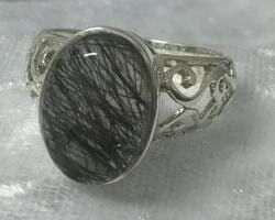 A Sleek Silver Ring Adorned with A Striking Black Stone — Crystal Cauldron In South Mackay, QLD