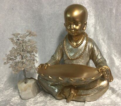 A Golden Figurine of A Seated Meditative — Crystal Cauldron In South Mackay, QLD