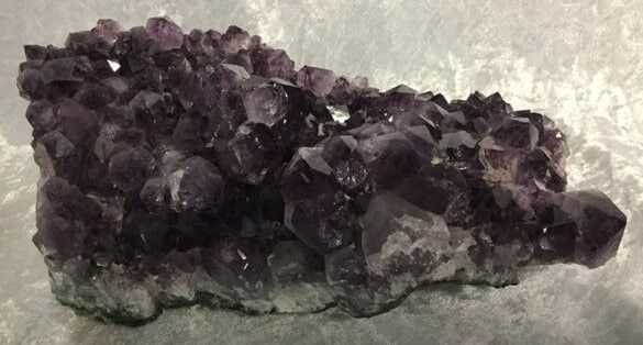 A Large Purple Rock Adorned with Shimmering Crystals — Crystal Cauldron In South Mackay, QLD