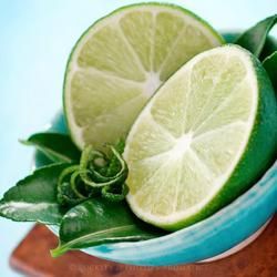 A Turquoise Bowl Holds Two Halved Limes — Crystal Cauldron In South Mackay, QLD