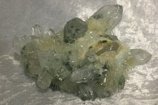 A Cluster of Translucent Quartz Crystals on a White Surface — Crystal Cauldron In South Mackay, QLD