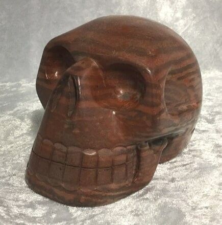 A Skull-Shaped Stone Displayed on A White Cloth — Crystal Cauldron In South Mackay, QLD