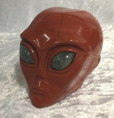 An Alien Head Displayed on A Vibrant Red Ceramic Plate — Crystal Cauldron In South Mackay, QLD