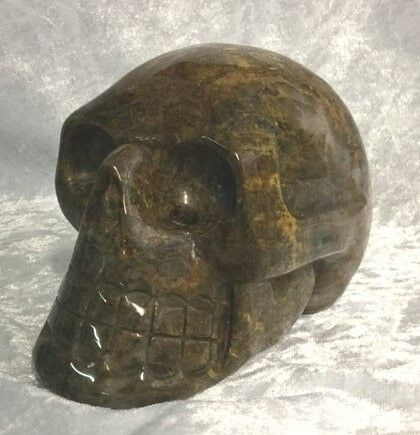 A Large Stone Skull Featuring a Prominent Black Face — Crystal Cauldron In South Mackay, QLD