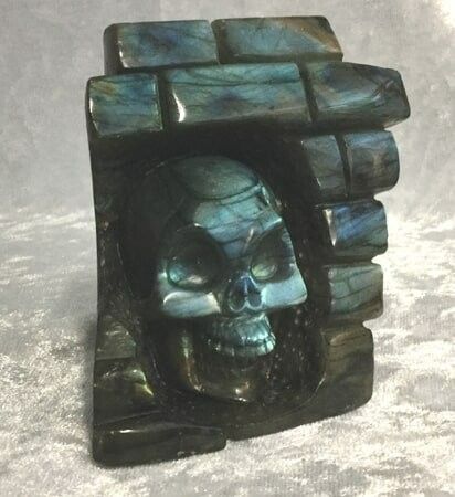 A Detailed Skull Positioned on A Rugged Stone Block — Crystal Cauldron In South Mackay, QLD