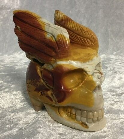A Ceramic Skull Adorned with Intricately Designed Wings — Crystal Cauldron In South Mackay, QLD