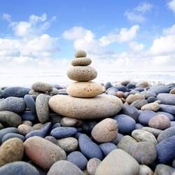A Balanced Stack of Smooth Stones Atop a Bed of Pebbles — Crystal Cauldron In South Mackay, QLD