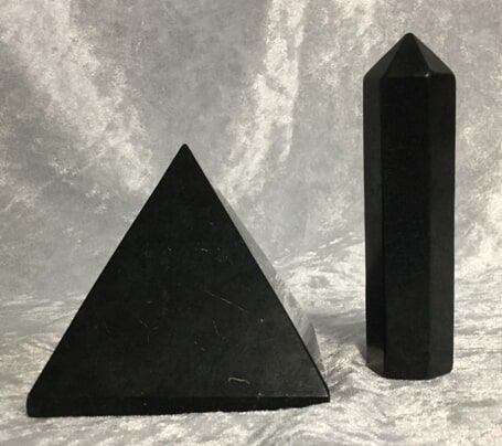Two Identical Black Pyramids Positioned Side by Side Against a Neutral Background — Crystal Cauldron In South Mackay, QLD