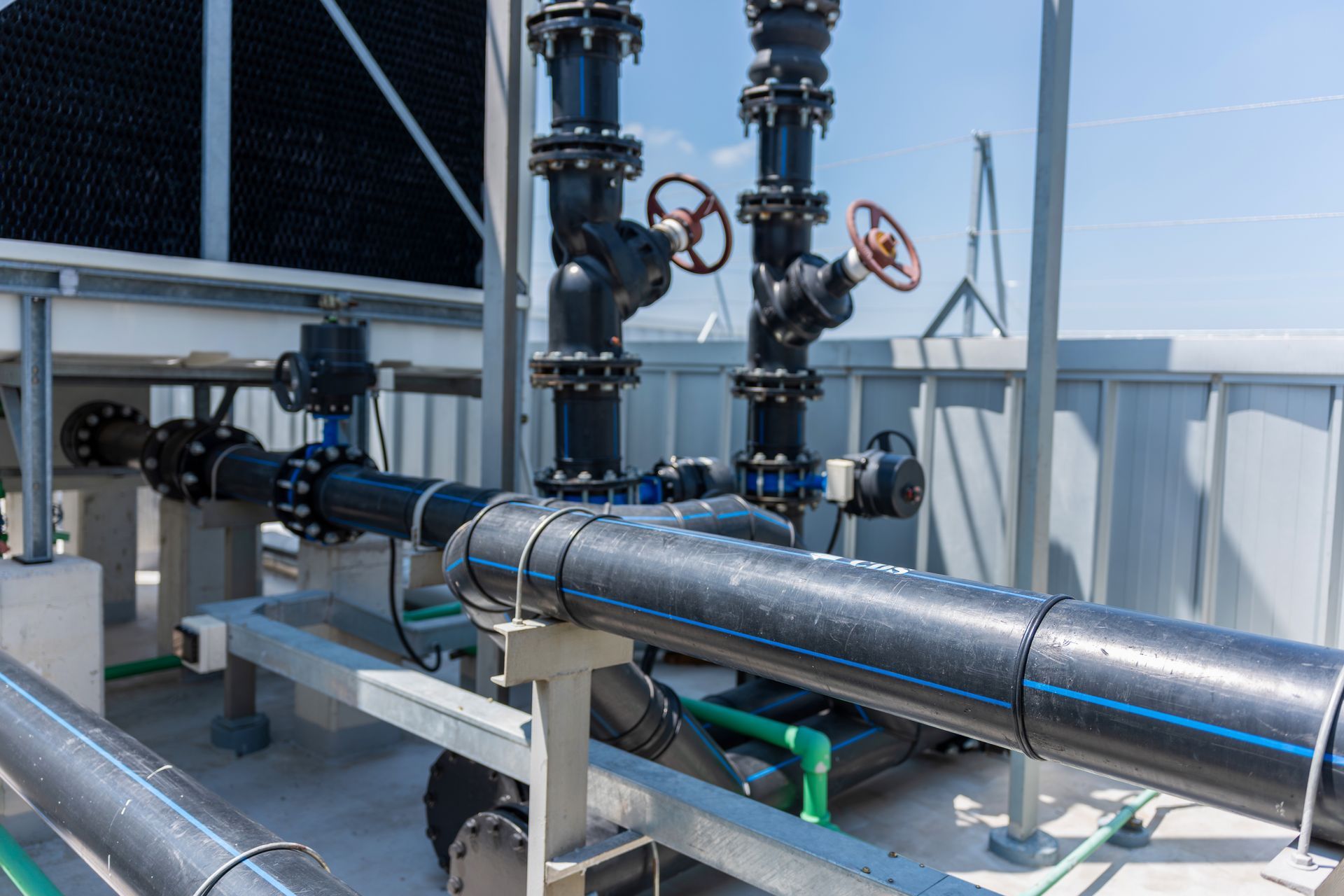 Industrial cooling tower pipe system and valves infrastructure on rooftop Industrial cooling tower pipe system and valves infrastructure on rooftop