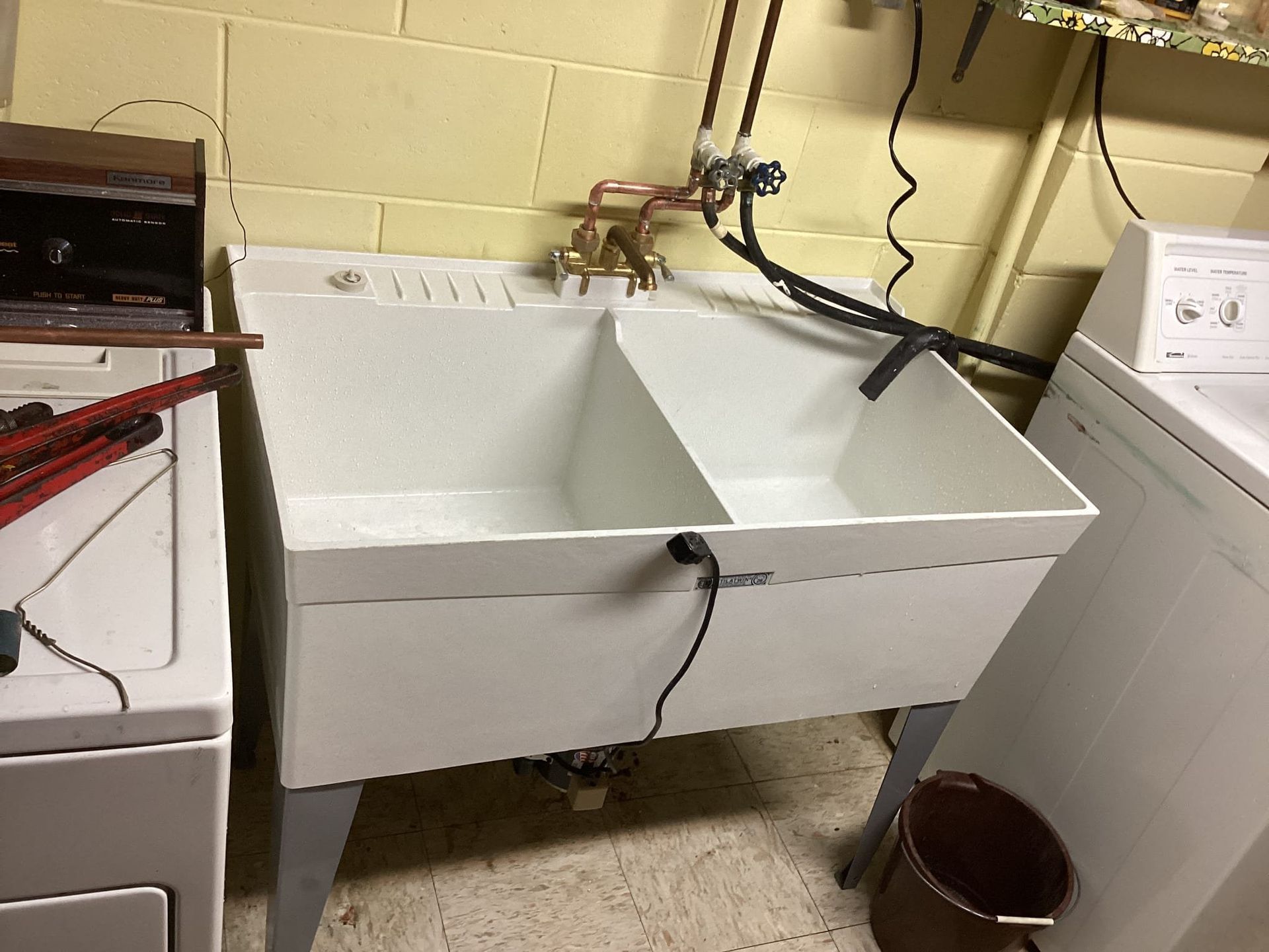 A laundry room with a sink and a washer and dryer