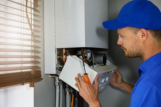 Man Repairing Heater — Victoria, TX — AAA Air Conditioning, Inc.