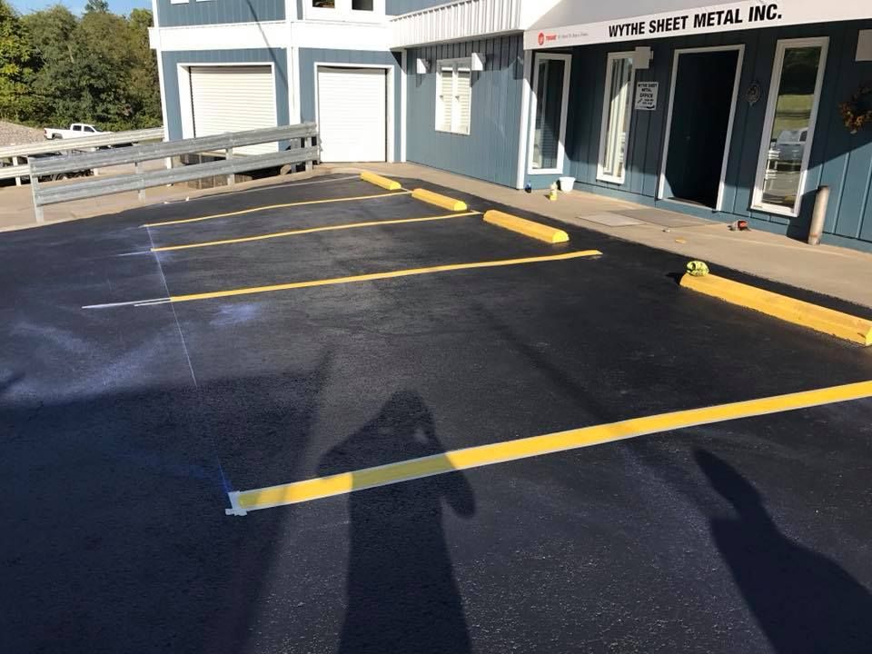 A parking lot in front of a building with yellow lines