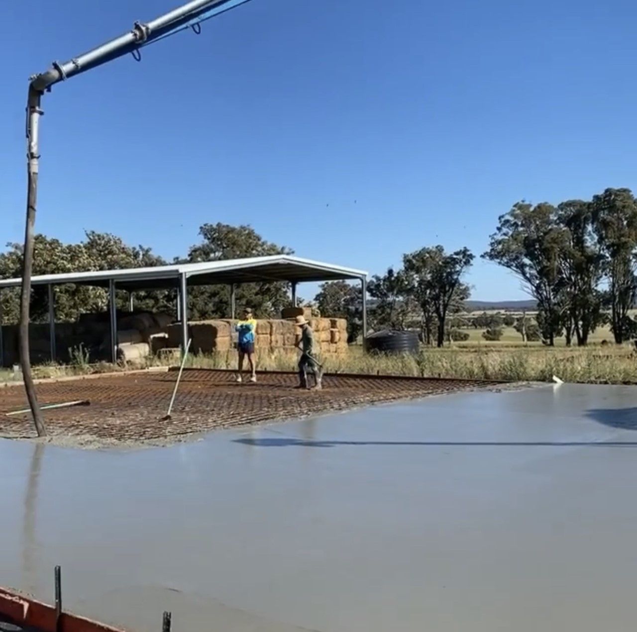 Man Pouring and Finishing a Concrete Driveway — Concreting in Inverell
