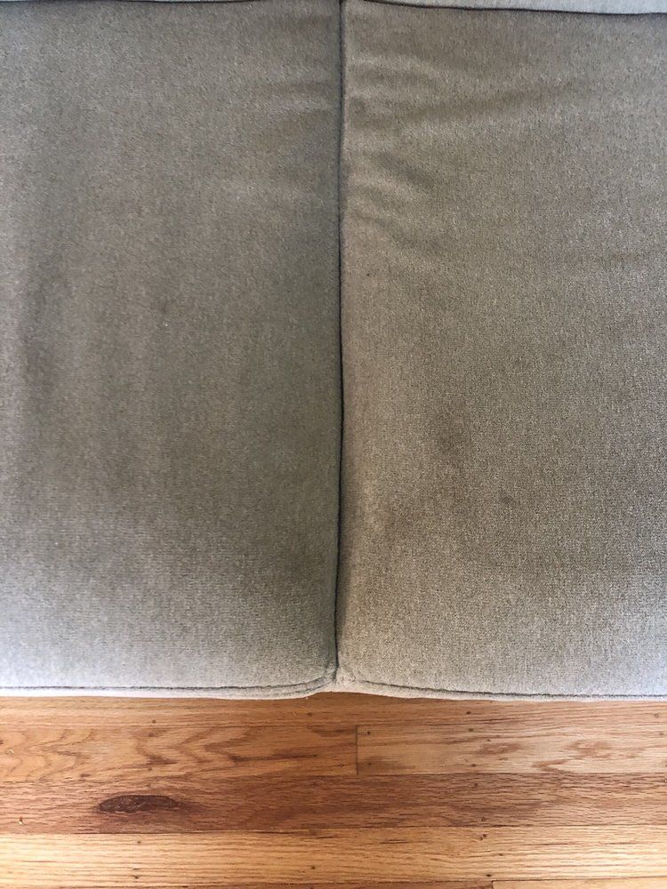 Close-up of a gray upholstered sofa above a wooden floor