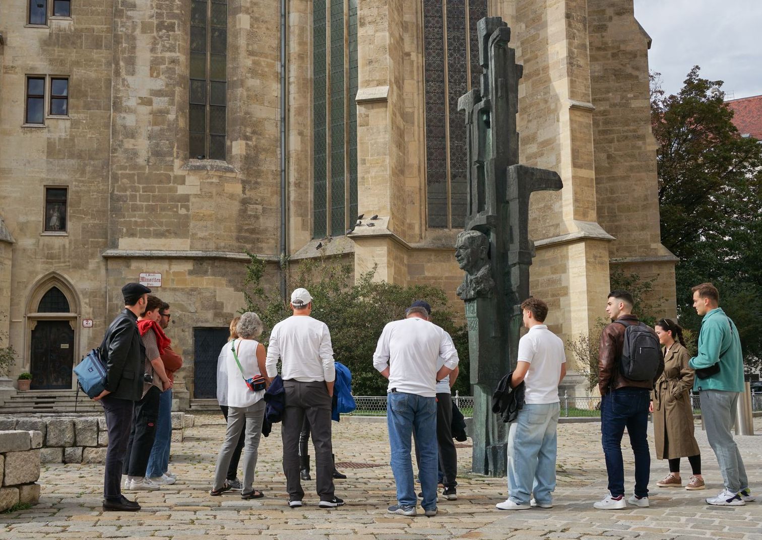 Tour guide leading a small group at St. Stephen's Cathedral during a Vienna Old Town walking tour