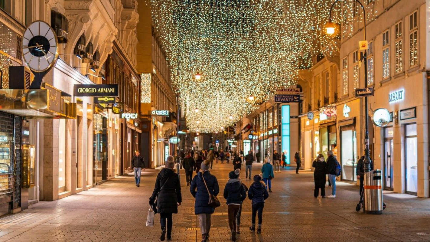 Shoppers walking under sparkling lights on Vienna’s Kohlmarkt at night Kohlmarkt street in Vienna at night with festive lights and evening shoppers