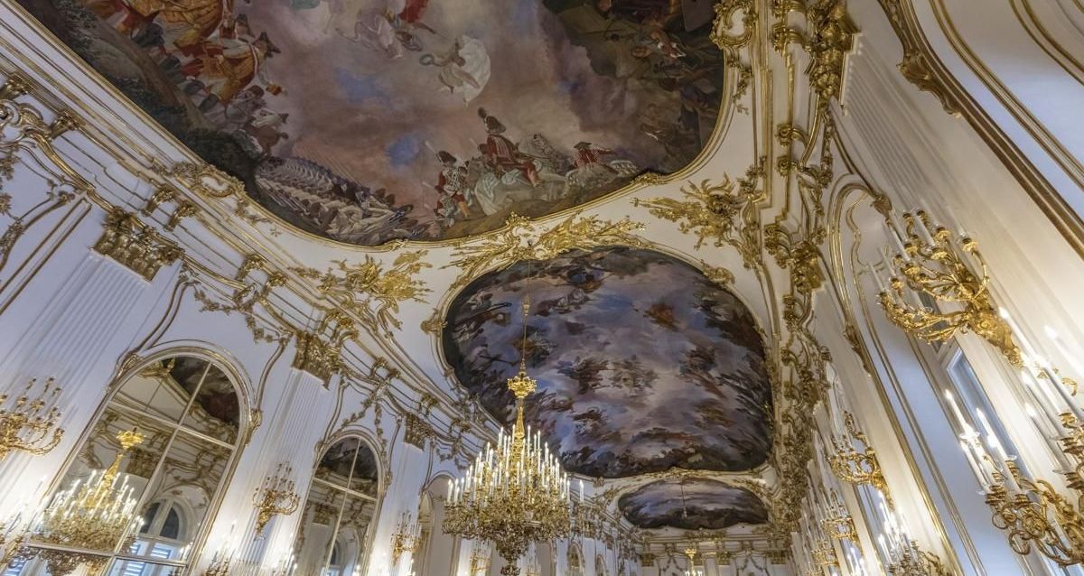 Lavish interior of Schönbrunn Palace with golden details and ceiling frescoes