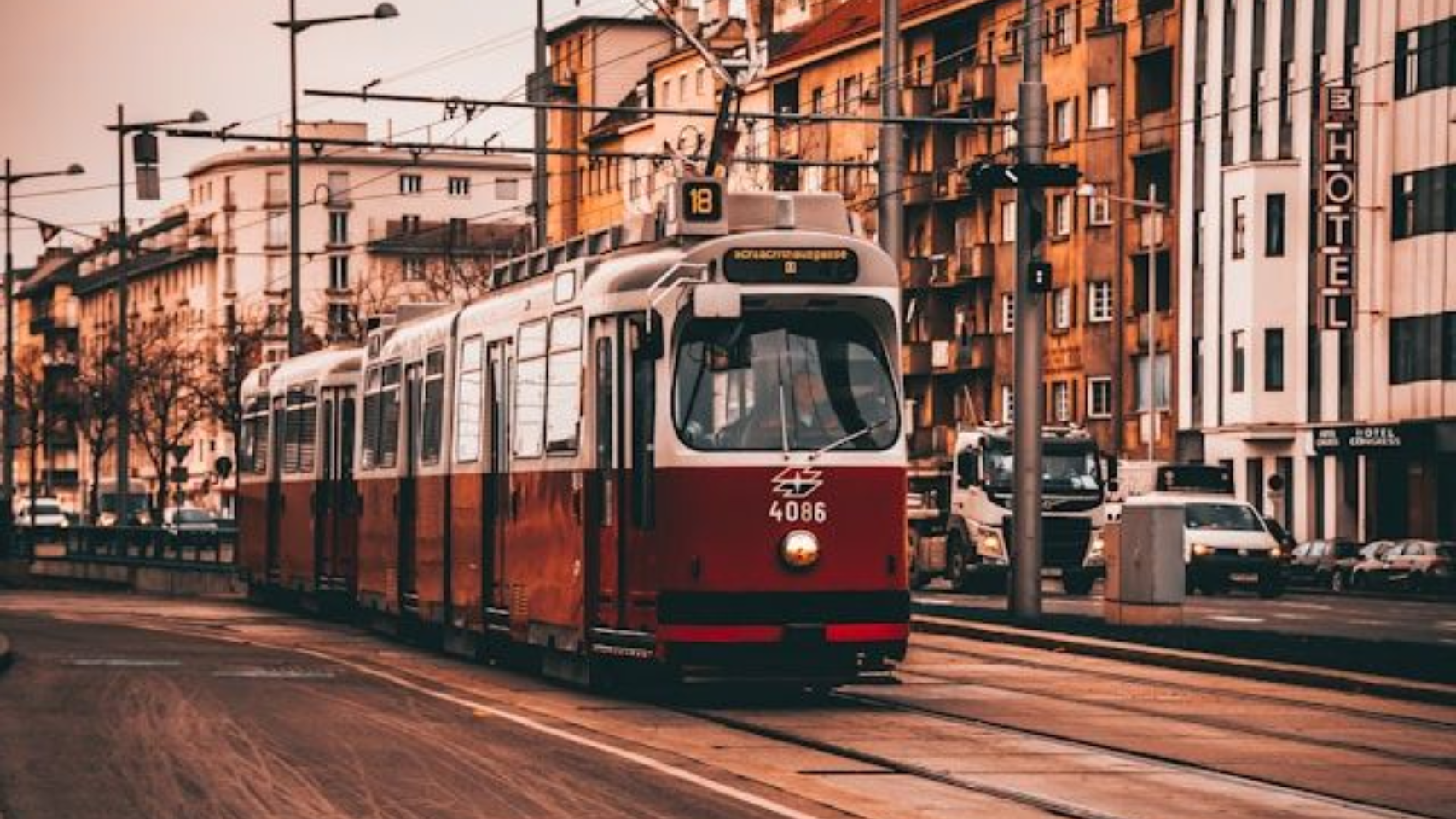 Red Vienna tram passing through historic city center