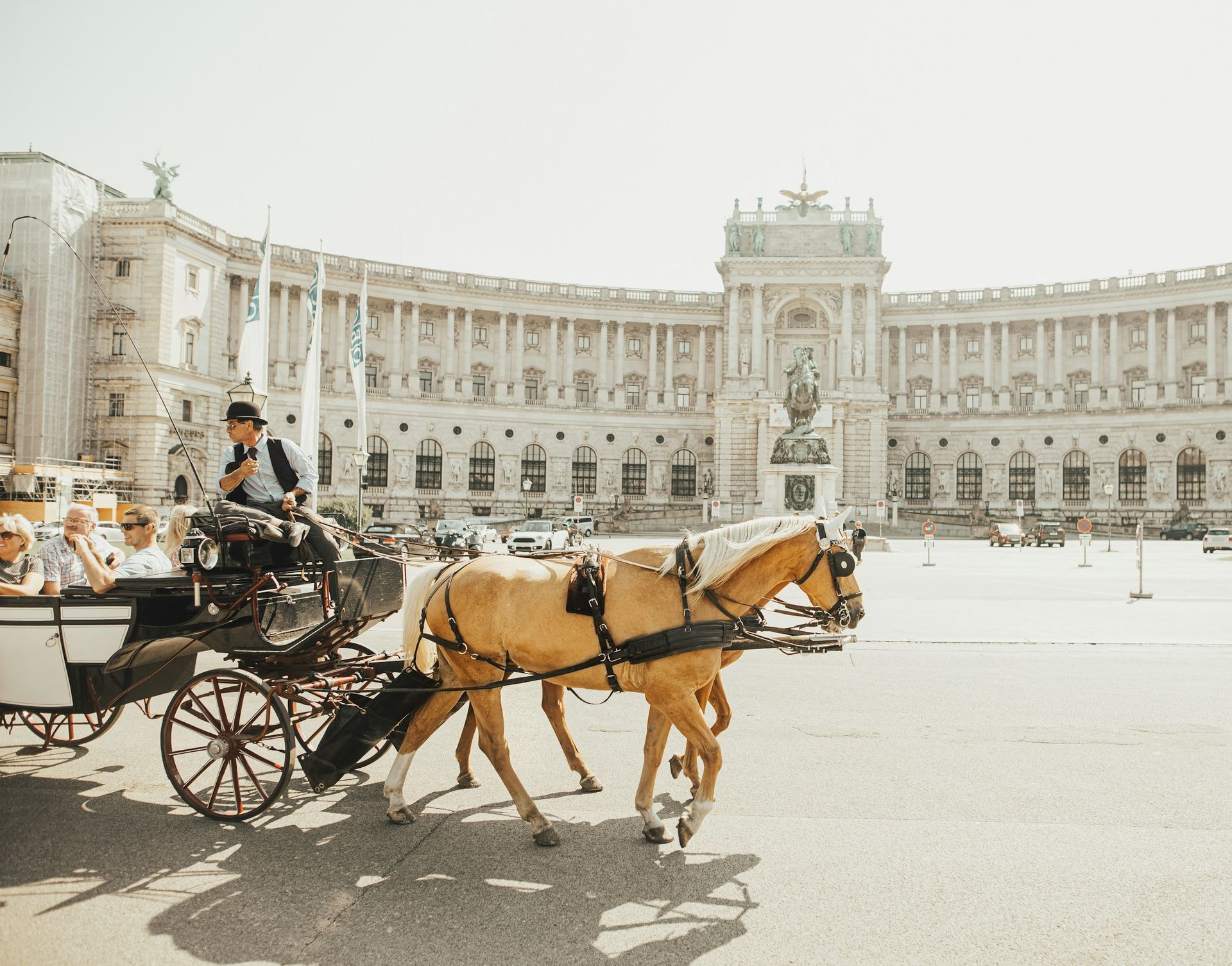 Horse-drawn carriage in front of Hofburg Palace in Vienna on a sunny day