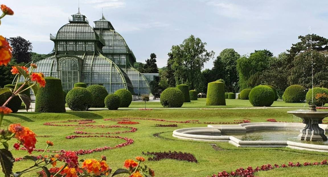 Vienna in spring – Schönbrunn Palace gardens with Palm House and colorful flower beds