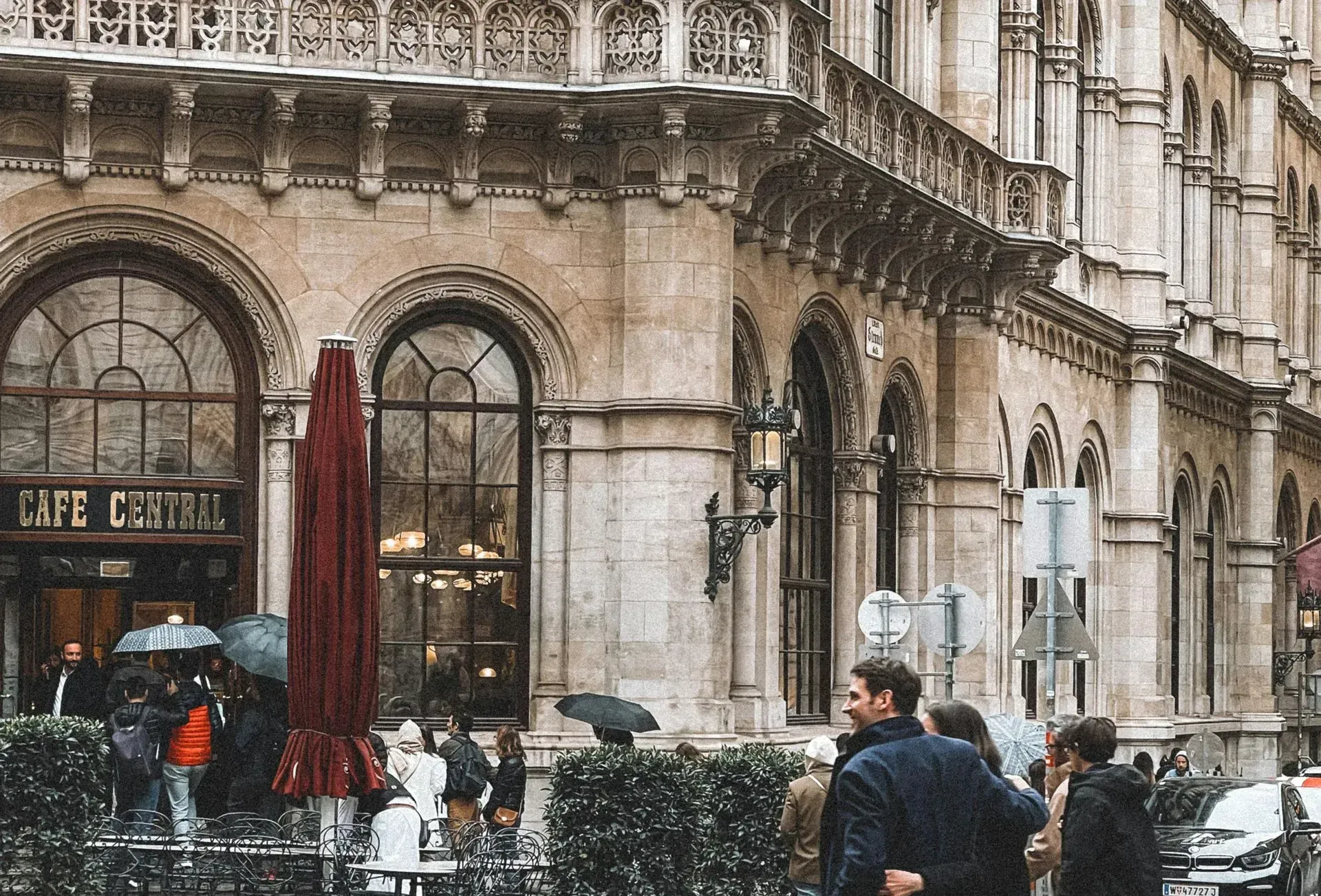 Café Central Vienna with visitors in winter coats and umbrellas—one of the best cafés to visit in February for warmth and pastries.