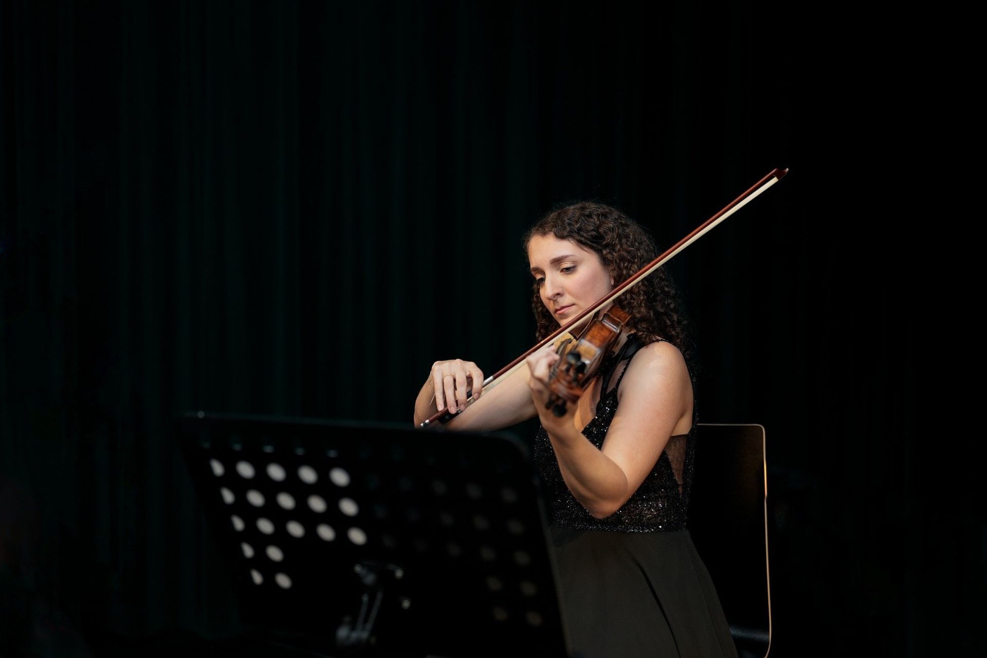 Female violinist performing live at the Viennese Classical Masters Concert in Haus der Musik, Vienna
