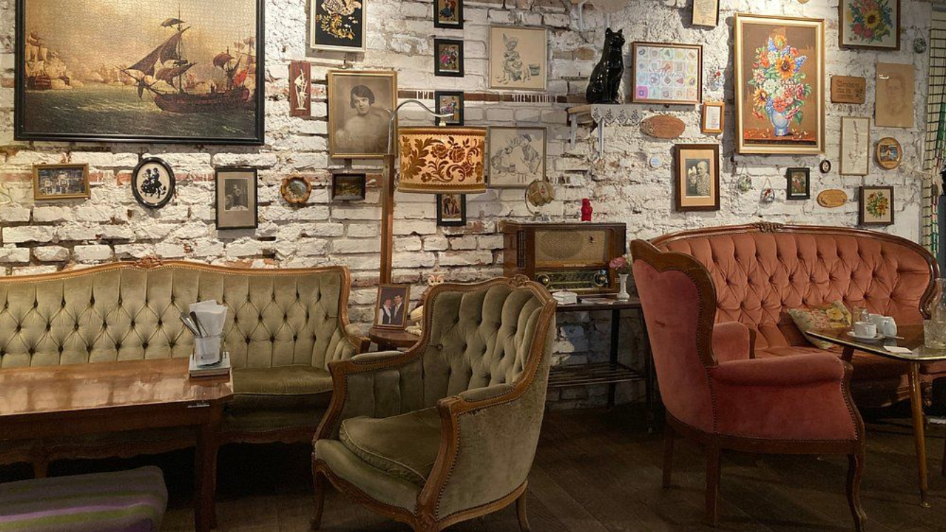 Cozy retro café setting inside Vollpension in Vienna Retro-style interior of Café Vollpension in Vienna with vintage furniture and wall art