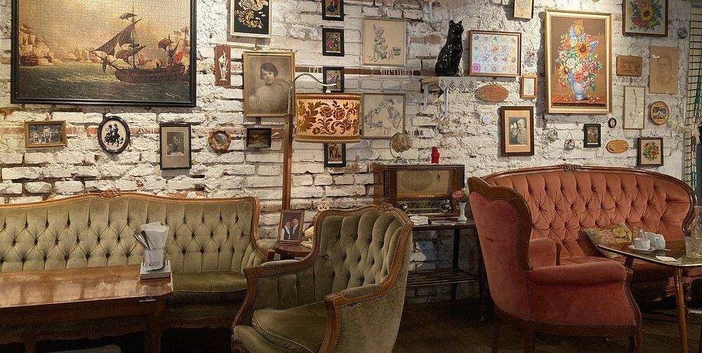 Vintage-style interior of Vollpension café in Vienna with cozy sofas and artwork