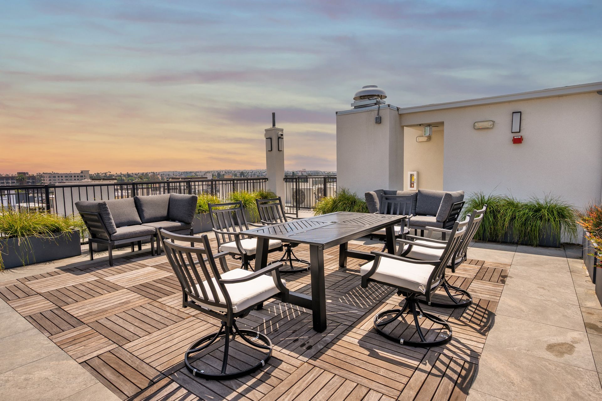 There is a table and chairs on the roof of a building.