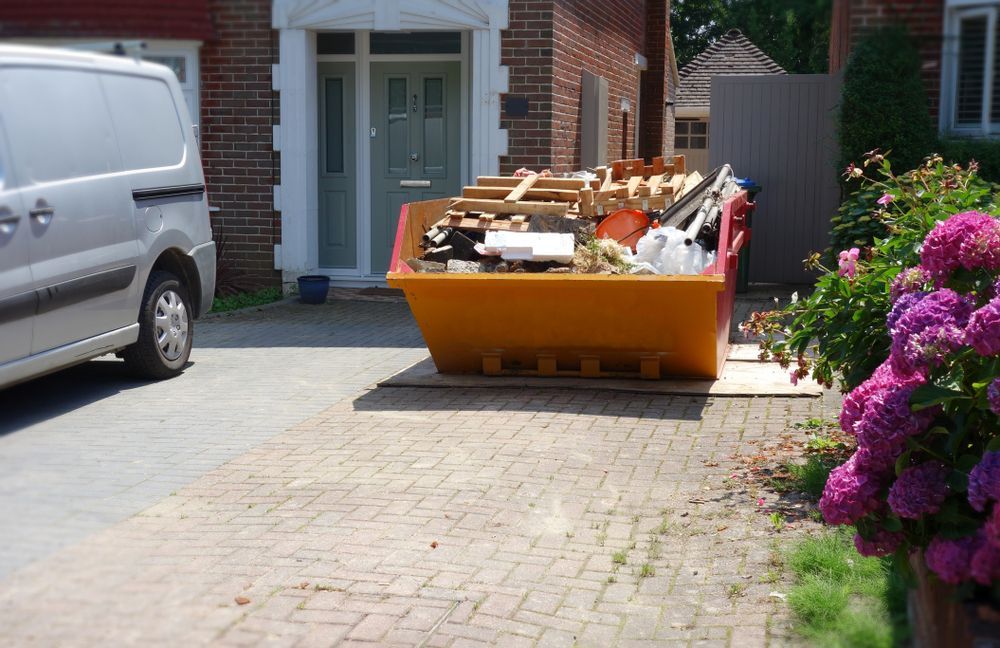Orange Skip Filled With Debris in a Driveway — Fat Boy Skips Townsville In Kirwan, QLD