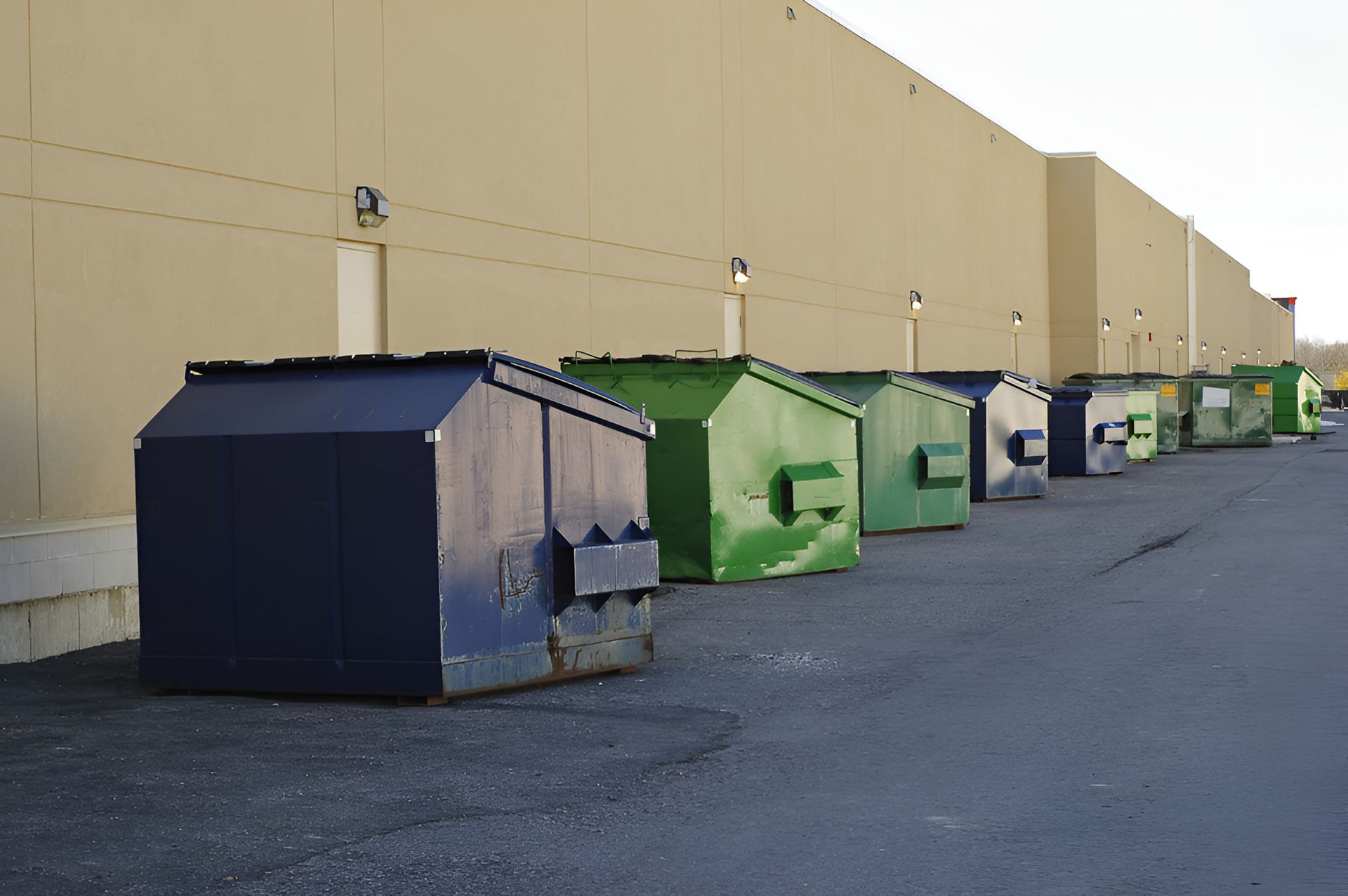 row of skip bins behind commercial building in Townsville