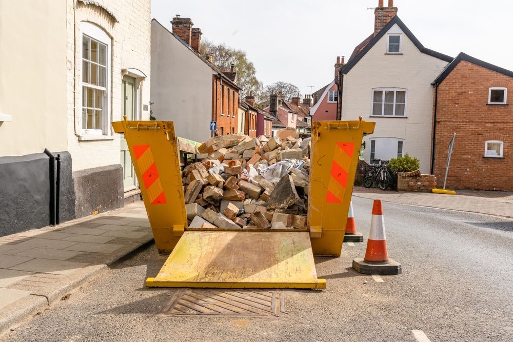 Yellow Skip Bin Filled With Rubble Sits on a Street — Fat Boy Skips Townsville In Burdell, QLD