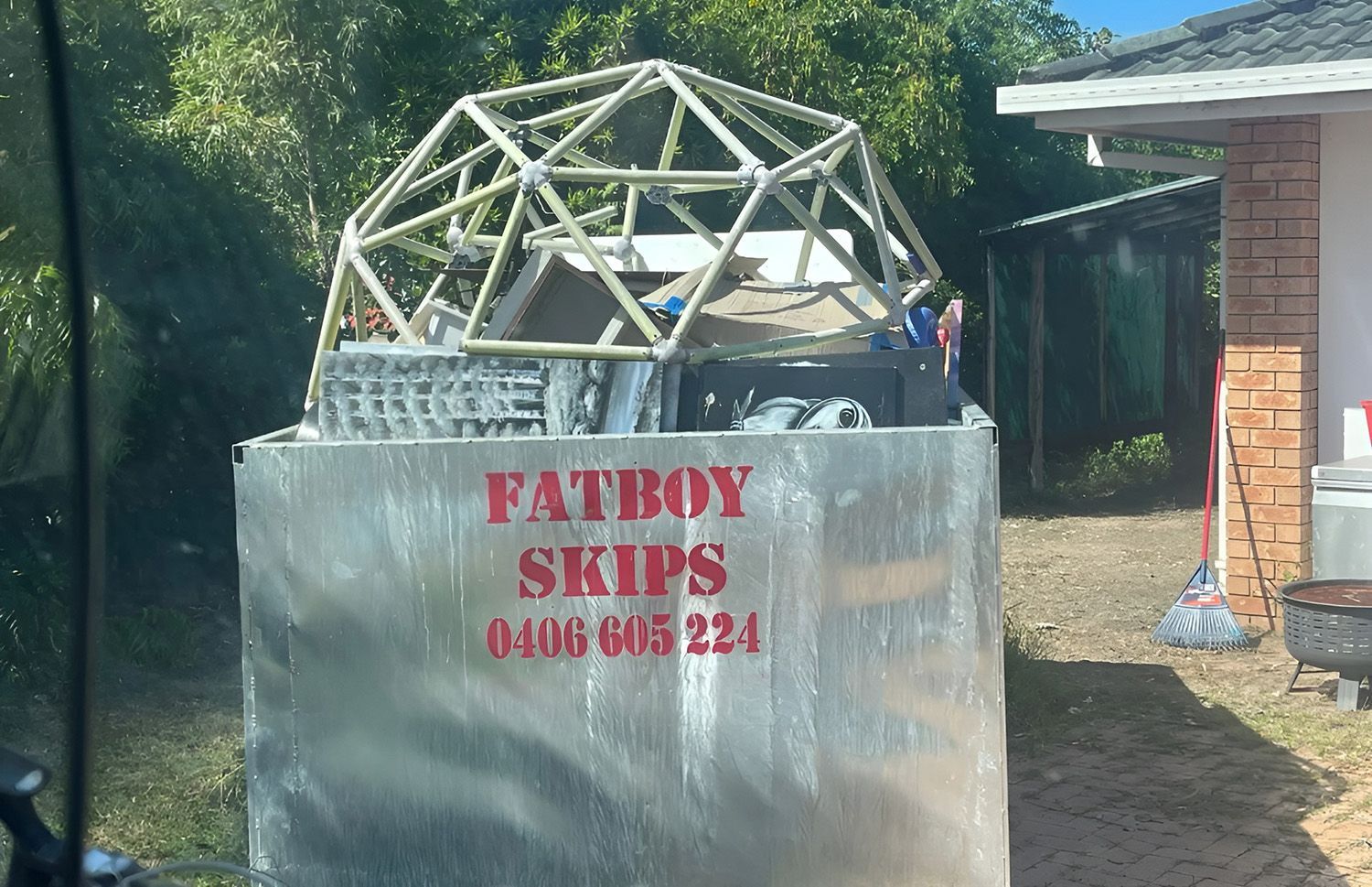 A Silver Skip Bin Labeled FATBOY SKIPS