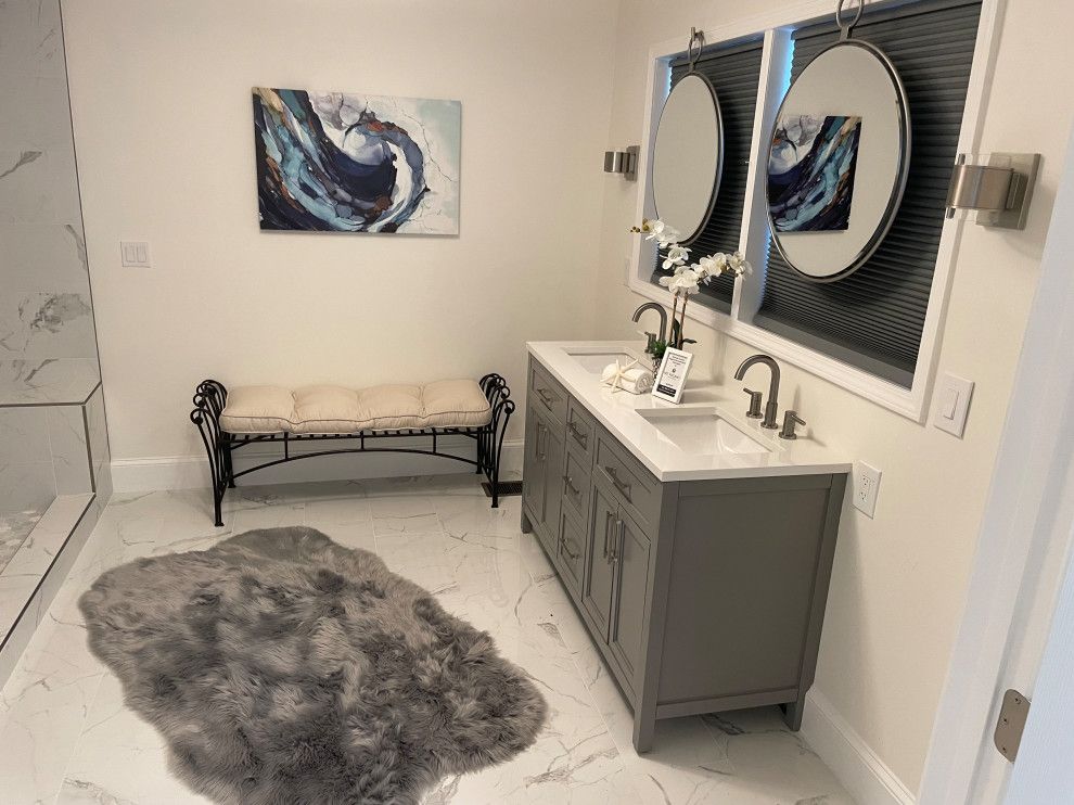 Modern bathroom with double vanity, wall art, bench, and gray rug