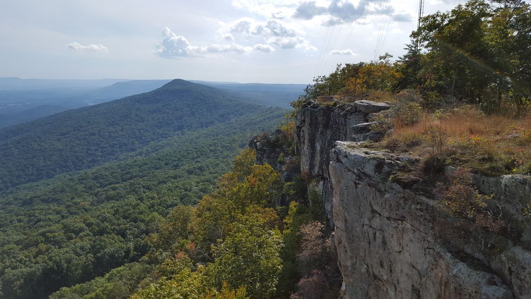 A view of a mountain range from the top of a cliff.