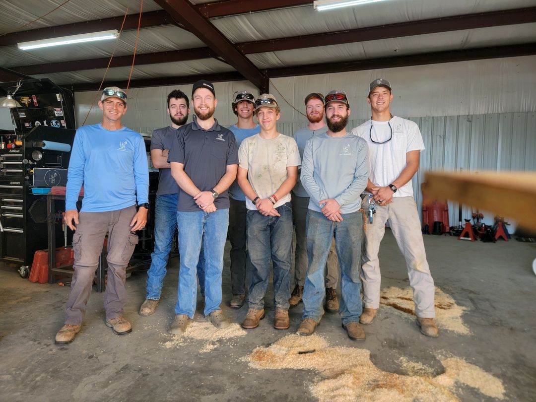 A group of men are posing for a picture in a garage.