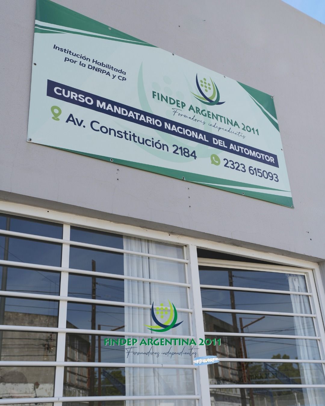 Vista trasera de una fila de coches grises estacionados con luces traseras rojas, iluminados por la luz del sol.