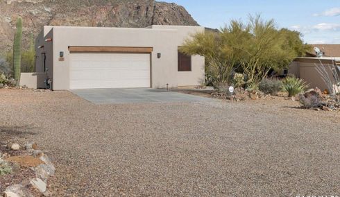 Gravel driveway winding through a wooded area.