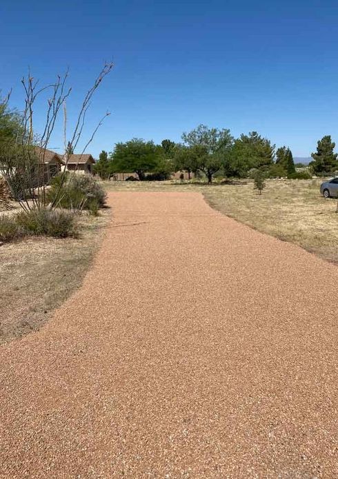 Freshly repaired gravel driveway leading to a home.