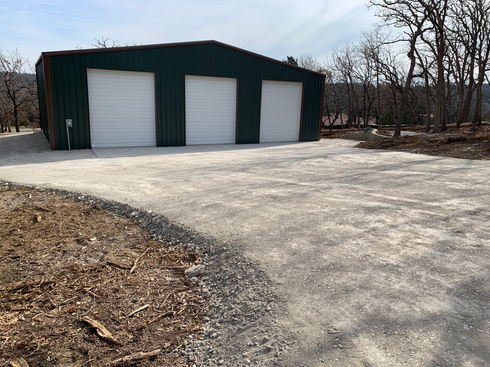 Freshly installed light-colored gravel driveway and parking area