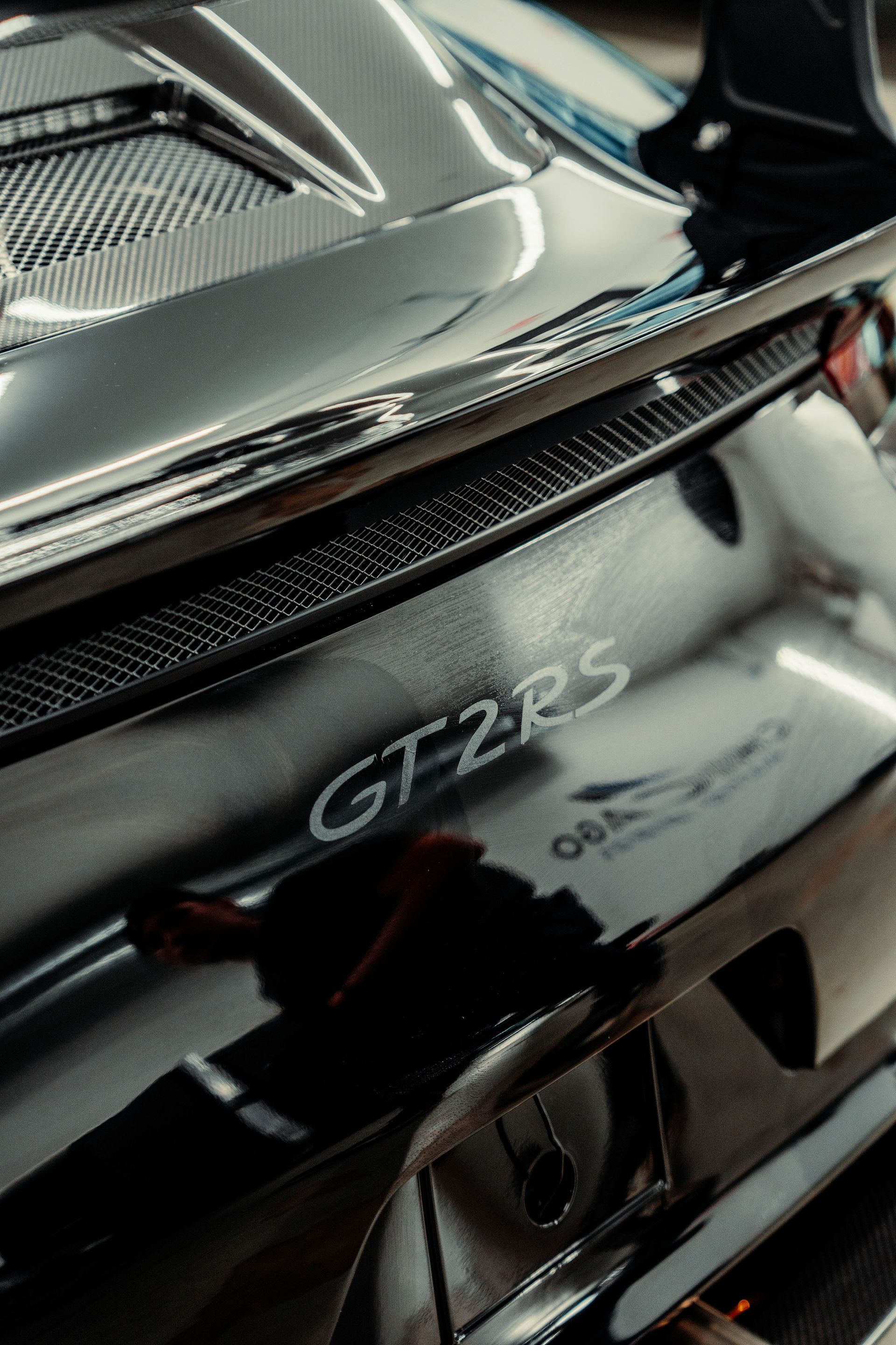 A close up of the back of a black porsche 911 gt2 rs.