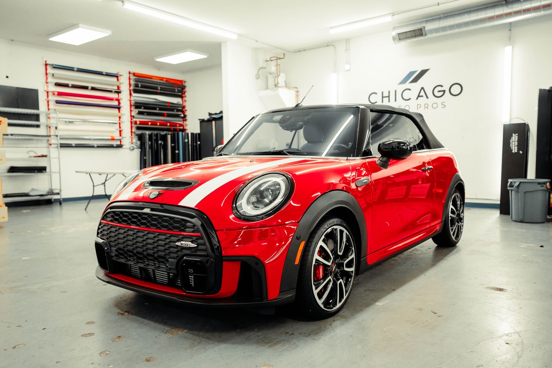 A red mini cooper is parked in a garage.