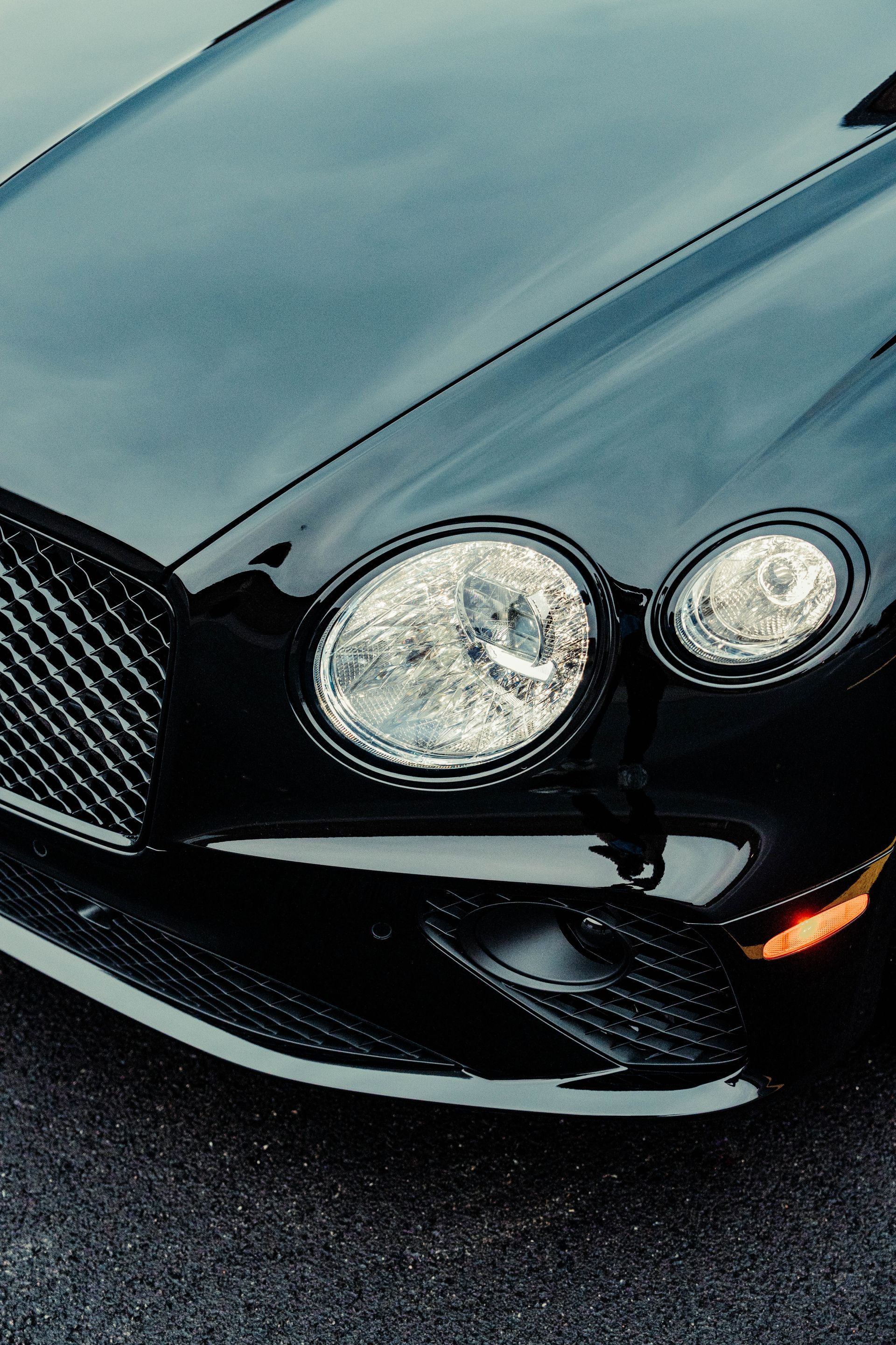 A close up of a black car 's headlights