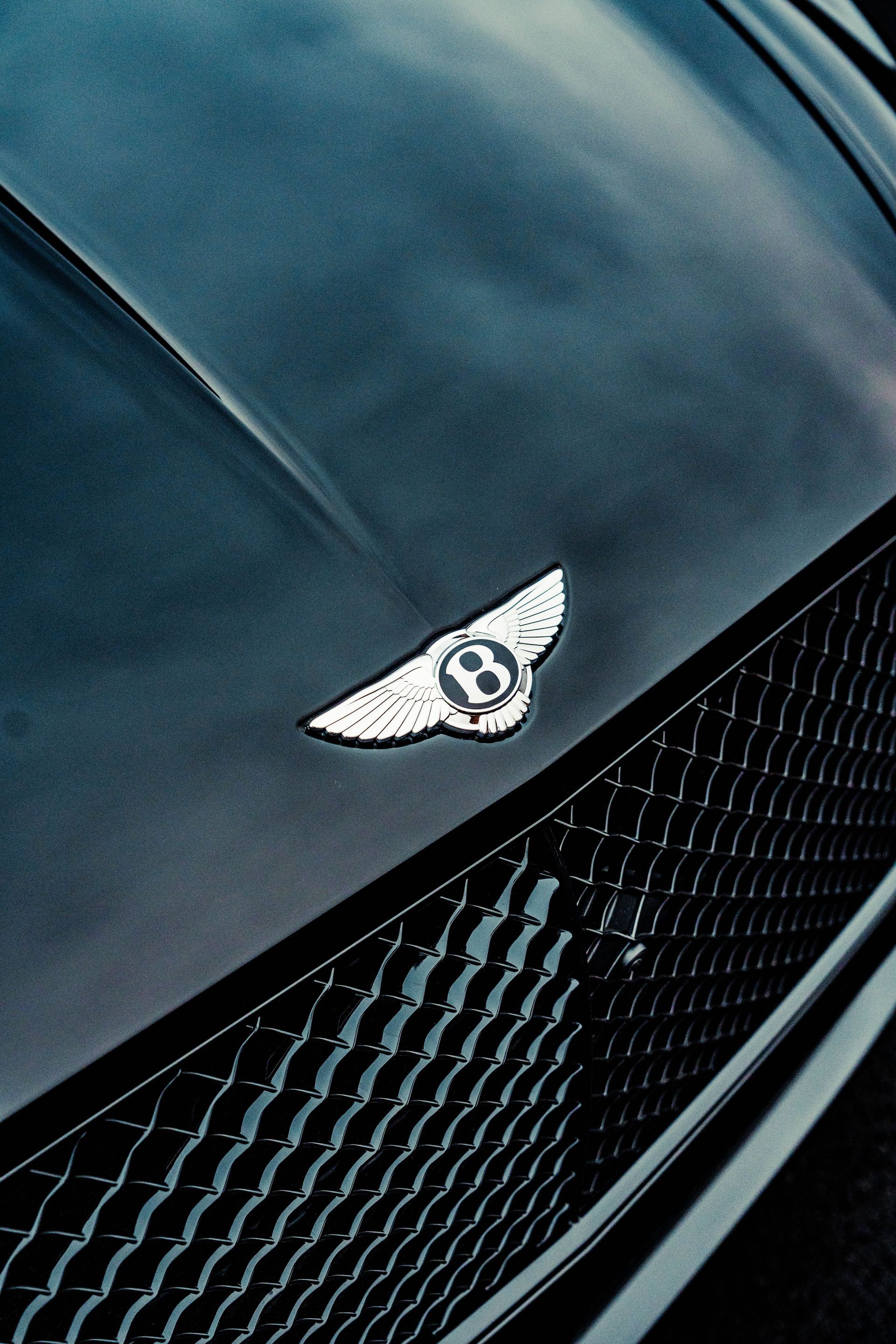 A close up of the hood of a bentley car