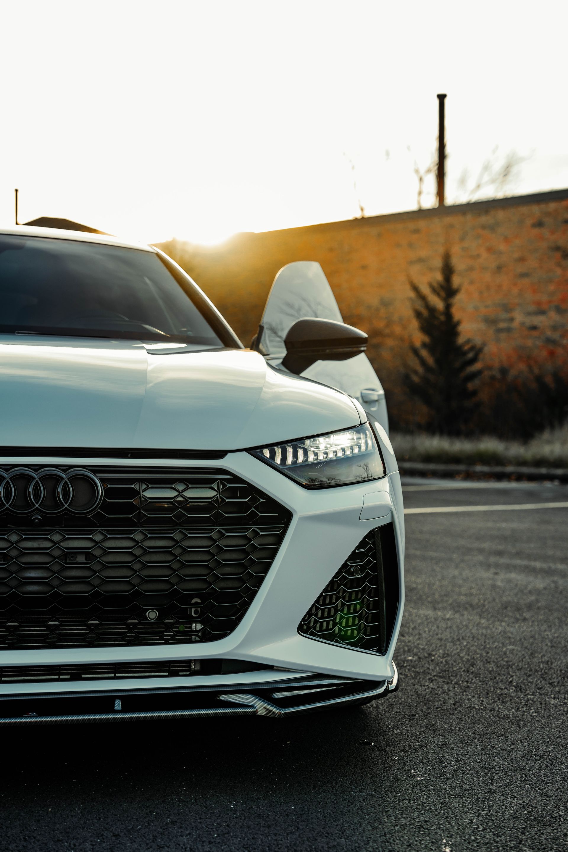 A white audi rs7 is parked in a parking lot.