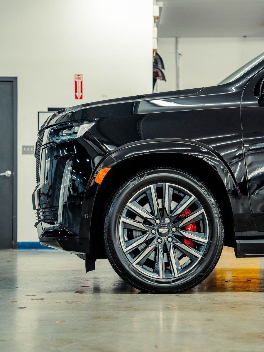 A black suv is parked in a garage.