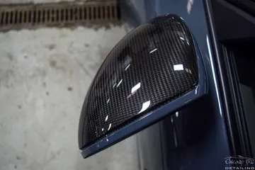 A close up of a side view mirror on a car.