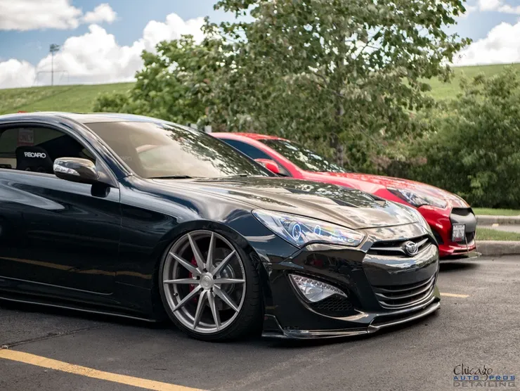 Three cars are parked next to each other in a parking lot.
